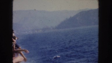 1952: a tour boat crowded with mountains in the distance CALIFORNIA