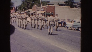 1954: four rows of soldiers march down a street on a sunny day SOUTH DAKOTA