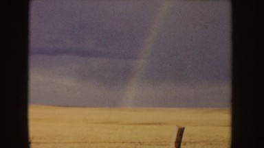 1955: rainbow on a wheatfield, nurse and her father out for a drive IDAHO