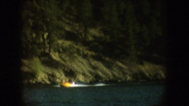 1954: A Small Yellow Watercraft Speeds Through a Still Lake South Dakota