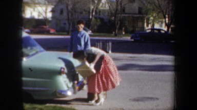 1957: a female inspecting her car WYOMING
