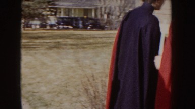 1955: Nurses in Red and Black Capes Entering a Building Idaho