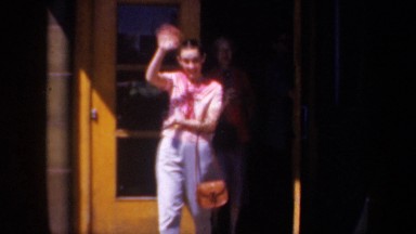 1957: women exiting the house and waving at the camera WYOMING