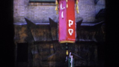 1957: people was pass a chinese restaurant while camera pans from up to down.