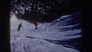 1962: Two Men Skiing Downhill, Carving Side-to-Side on Snowy Slope