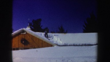 1962: a man clearing the roof of a house almost completely covered by snow NEW