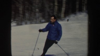 1962: a single person in a blue coat skiing down a hill NEW HAMPSHIRE