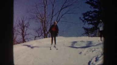 1962: two adult woman skiing down a snow covered hill together VERMONT