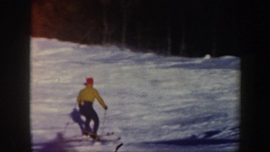 1962: a man skiing in the snow, down a mountain. VERMONT