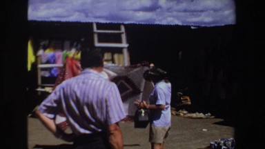 1969: Salesman Attempting to Persuade Tourists to Purchase Rugs in South Africa
