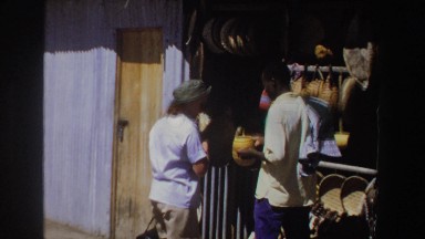 1969: Woman Browsing Handcrafted Souvenirs in a South African Shop