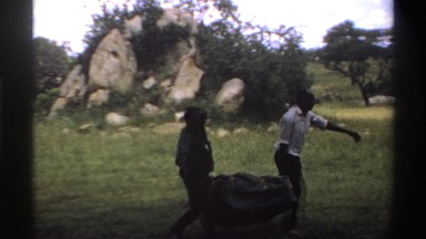 1969: men hauling the canvas and poles for a tent NIGERIA