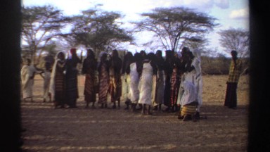 1969: People in Row Wearing Wrapped Garments and Head Scarves Clap Rhythmically