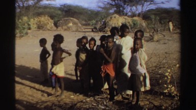1969: A Group of Black African Children Dressed in Tribal Clothing Walking Through a Sudanese Village