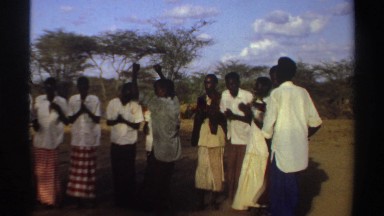 1969: Friends Dancing Joyfully on Lawn in Sudan