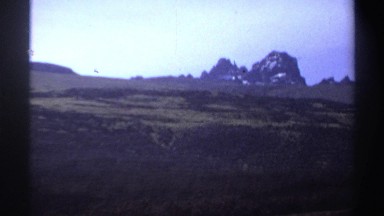 1969: Two Men Eating Lunch in a Field with Packs Sudan