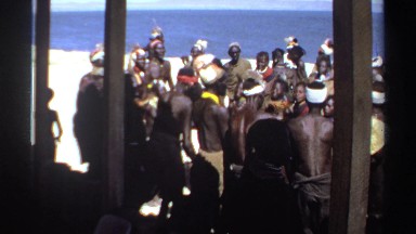 1969: tribal dance in formal wear in a circle with their children having a good