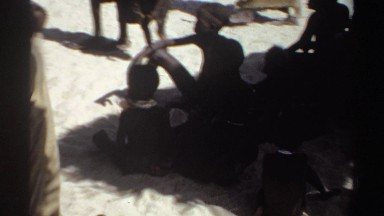 1969: children sitting under shadow and walking around the place SUDAN