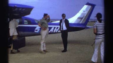 1969: people about to enter the airplane, lions are resting upon the rock SUDAN