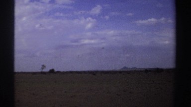 1969: A Small Landing Aircraft Flying Low Over a Field in Sudan