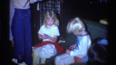 1975: Two Children Holding a Red Cloth in Florida Living Room