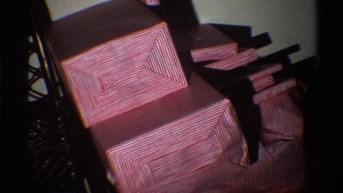 1975: Lots of Wrapped Gifts Stacked on a Chair in Florida