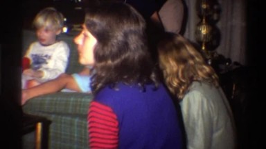 1975: a family has casually gathered in a living room around the couch FLORIDA