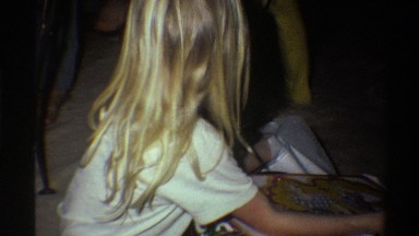 1975: mom helps daughter unwrap presents FLORIDA