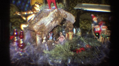 1975: hand touches santa claus figurines when an arm carries a branch by a