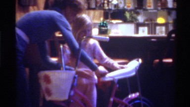 1975: a girl sitting on a bike with the help of her mum FLORIDA
