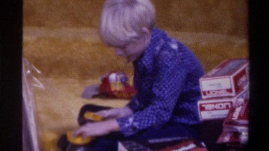 1975: young boy attempts to build a toy on christmas morning. FLORIDA