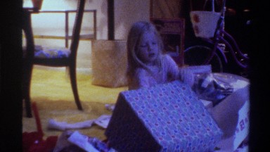 1975: lady helping a young girl to unpack a gift box FLORIDA