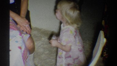 1974: Young Blonde Toddler in Pink and White Dress Smiling and Clapping