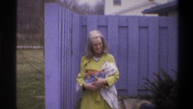 1973: a thirteen second clip of a young mother holding a blanket and a toy,
