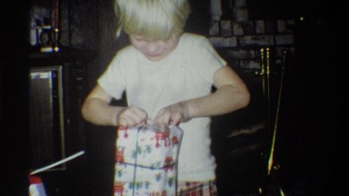 1973: two young siblings eagerly opening their presents. NEW YORK