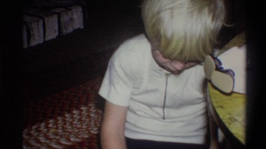 1973: small silver haired boy sitting on the floor and playing with toys NEW
