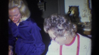1973: a young lady and an older lady work together wrapping gifts. NEW YORK