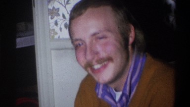 1973: a man with a mustache laughs at something off screen NEW YORK