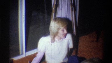 1973: Young Blonde Girl Sitting on Floor Talking in Living Room New York