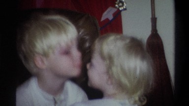 1973: blonde siblings playing together, inside the house. NEW YORK
