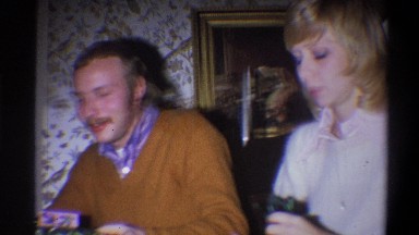 1973: a smiling man and his wife unwrapping presents NEW YORK