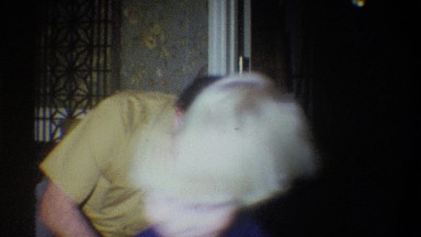 1973: a little boy smiles as he takes something from his grandfather's hands NEW