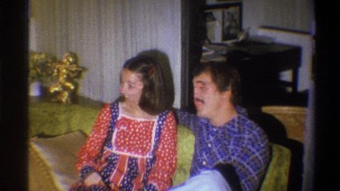1973: a happy couple talking and smiling to each other and the camera NEW YORK