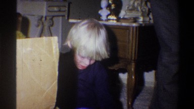 1973: excited boy opening a gift NEW YORK