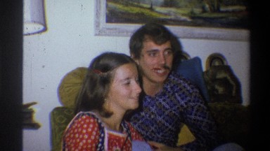 1973: a happy couple talking and smiling to each other and the camera NEW YORK
