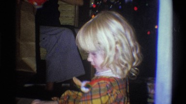 1973: christmas event with child opening a present NEW YORK
