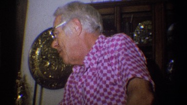 1973: christmas with a man in a pink and purple checked shirt talking and a
