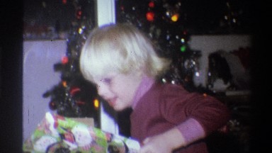 1973: a boy excitedly opening christmas gifts NEW YORK