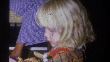 1973: little girl opening present NEW YORK