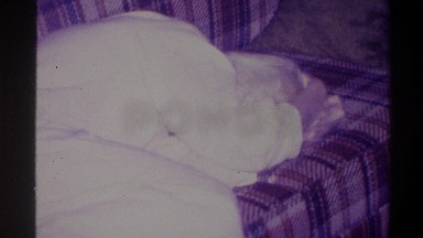 1973: someone sleeping on the couch, with a kid walking by NEW YORK